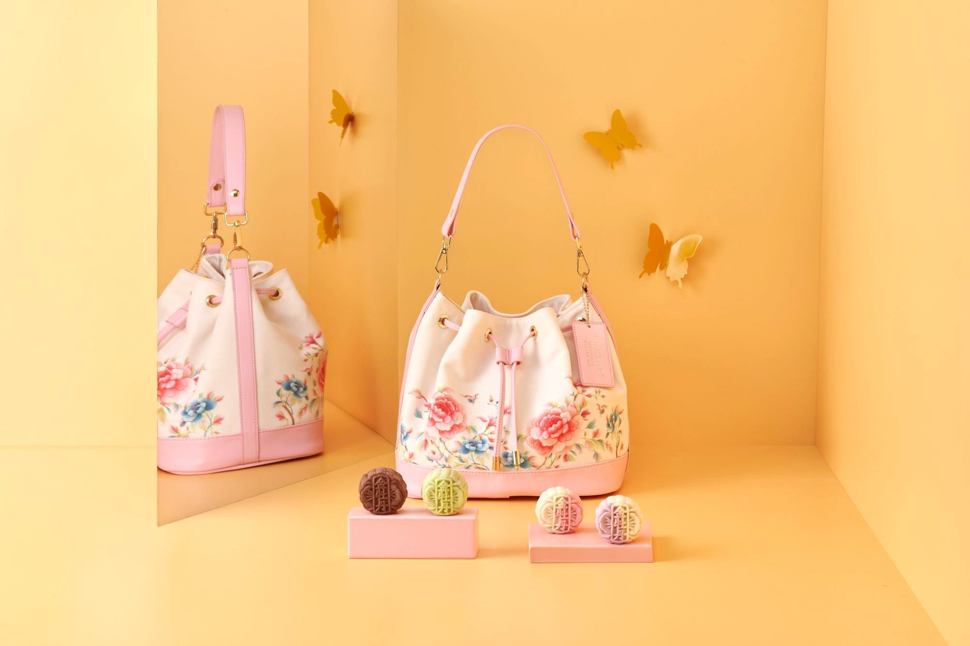 Two elegant gift bags, one red and one beige, displayed traditional mooncakes