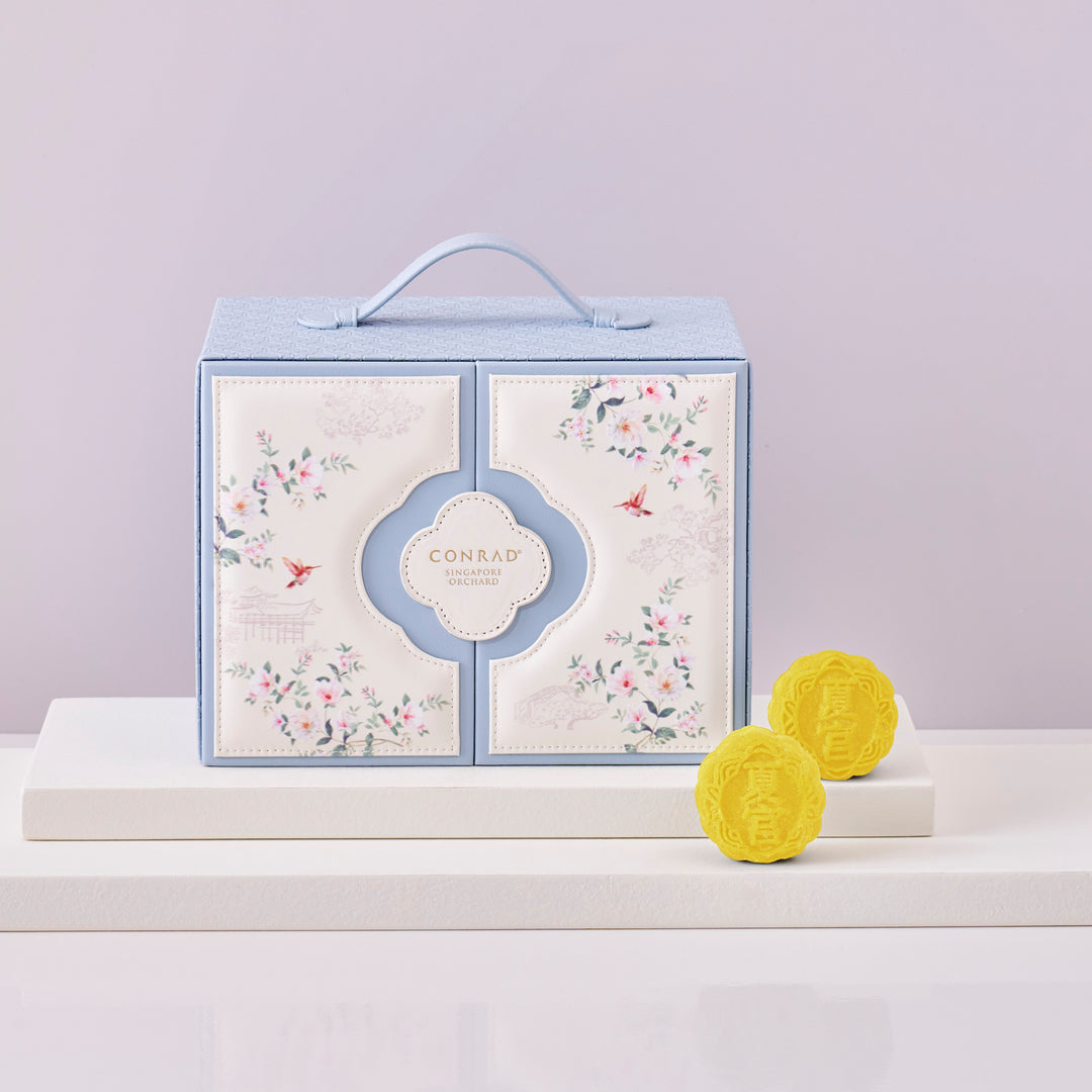 Conrad branded product packaging with two yellow items on a light purple background
