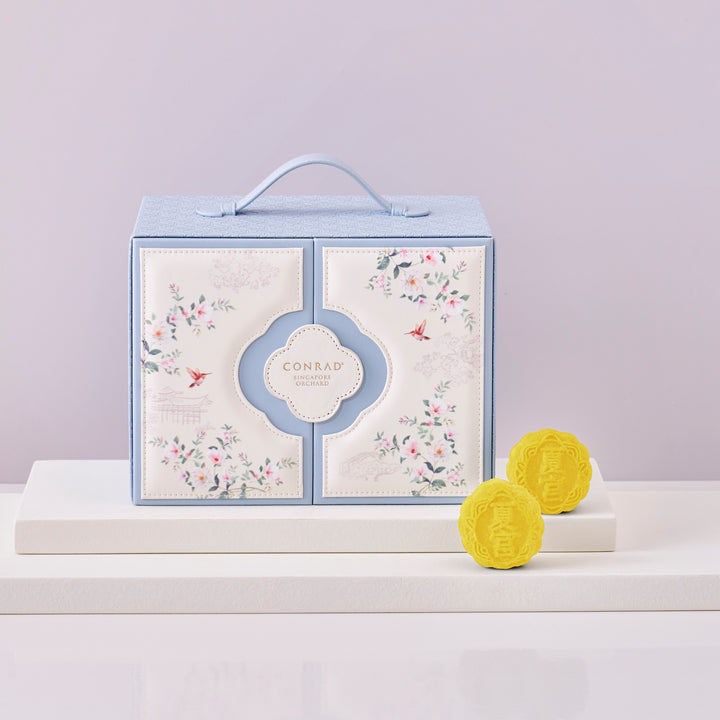 Conrad branded product packaging with two yellow items on a light purple background